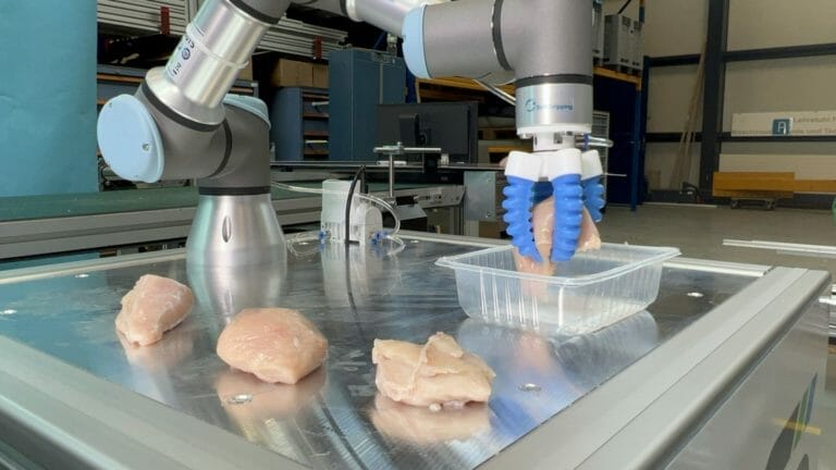 gripper holding a chicken breast for packaging